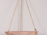 an image of a pink glass hanging bowl on a rope