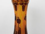 a brown and black vase sitting on a table