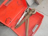 a red tool box with a pair of scissors in it