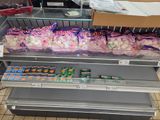 many bags of candy on the shelves in the store
