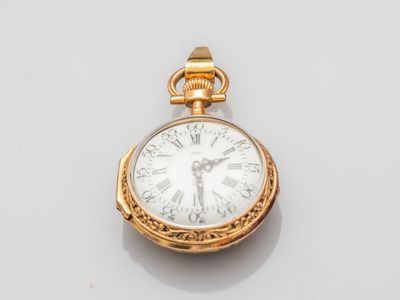a close up of a gold pocket watch with roman numerals on the face