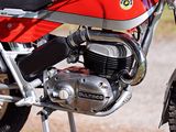 a red and black motorcycle parked on the side of the road