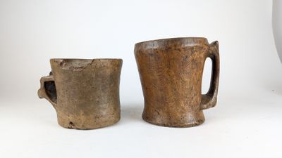 two coffee mugs sitting next to each other on a table
