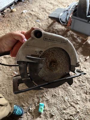 a person holding a circular saw in their hand