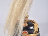a black helmet with a gold decoration on top of it