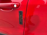 a close up of a car door handle with a sticker on it