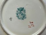 a plate with a coat of arms and a crown on it