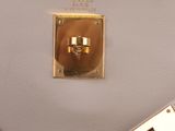the inside of a white purse with a gold handle and two handles