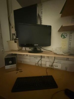 an image of a computer desk with a monitor and keyboard