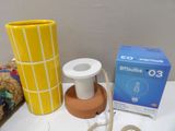 a yellow vase and a white lamp on a table