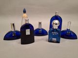 three blue glass bottles with a silver top and a silver top