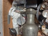 a cardboard box with a lot of silver items in it