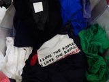 a pile of clothes that is sitting in a trash can