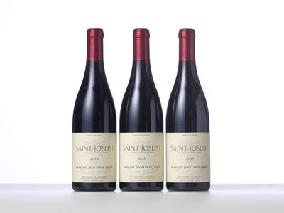 three bottles of wine sitting on top of a table