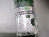 a roll of green grass that is wrapped in plastic