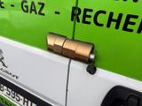 a close up of a green and white van with a key on the door