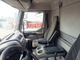 a view of the inside of a truck from the driver ' s seat