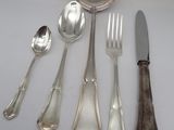 a lot of silver spoons and spoons on a table