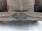 a close up of a metal object on a white surface