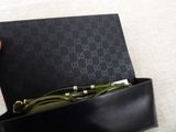 someone is holding a pair of glasses in a black box