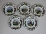 four plates with different designs on them on a white surface