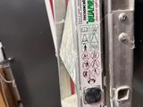 a close up of a metal door with a sticker on it