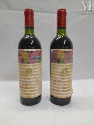 two bottles of wine sitting on top of a table next to each other