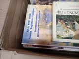 many books in a box that are sitting on a table