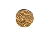 a close up of a gold coin on a white surface