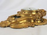 a gold clock sitting on top of a table