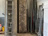 a room with a refrigerator and a ladder in it