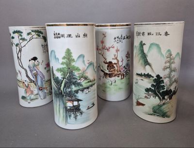 quatre vases ornés de motifs asiatiques, posés sur une table