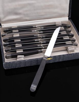 six knives in a case with a knife on top of it