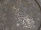 a metal plate that has a writing on it