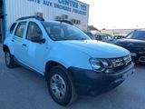 a picture of a blue dacia parked in front of a building