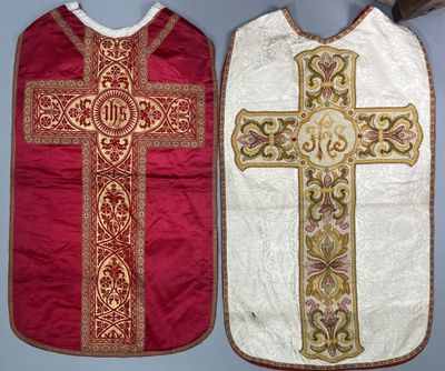two vests with a cross on them on a table