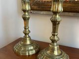 two candles that are sitting on top of a wooden table