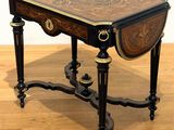 a small table with a wooden top on a hard wood floor