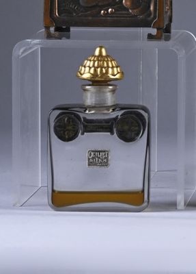 a bottle of perfume with a clock on top of it