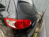 a picture of a black car parked in a parking lot