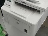 a white printer sitting on top of a white cabinet