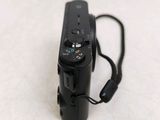 a black camera that is sitting on a white surface