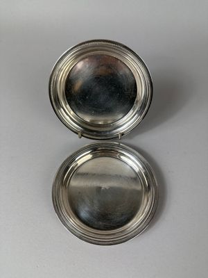 silver plated pill case with mirror on a white surface