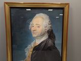 tableau représentant un homme aux cheveux blancs et vêtu d'une veste noire