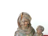 a statue of a woman holding a child in her lap