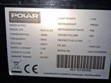a label on the back of a black refrigerator