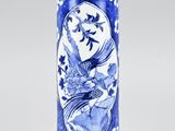 blue and white vase with a bird and flower design on it