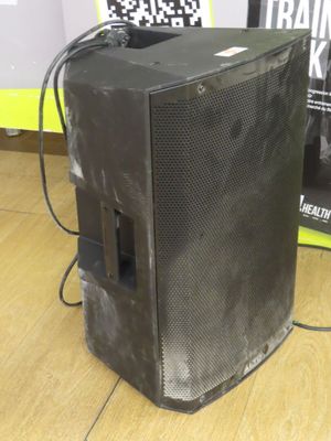 a speaker that is sitting on the floor next to a wall