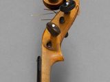 a close up of a violin on a gray surface