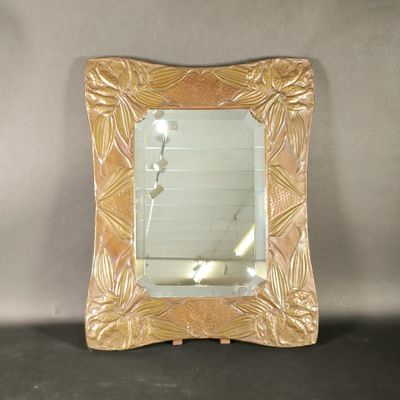 a mirror that is sitting on a table in a room